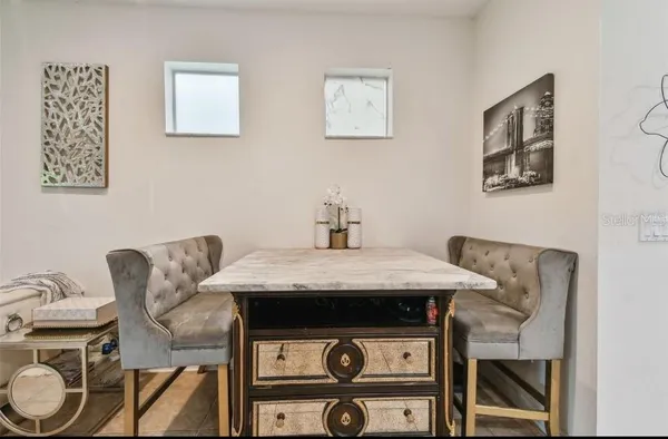 a view of a dining room with furniture and wooden floor