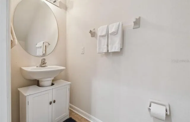 a bathroom with a sink a mirror and a toilet