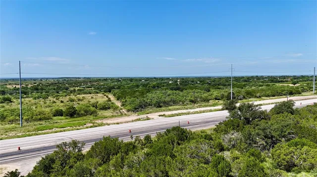 a view of a yard with an ocean and trees