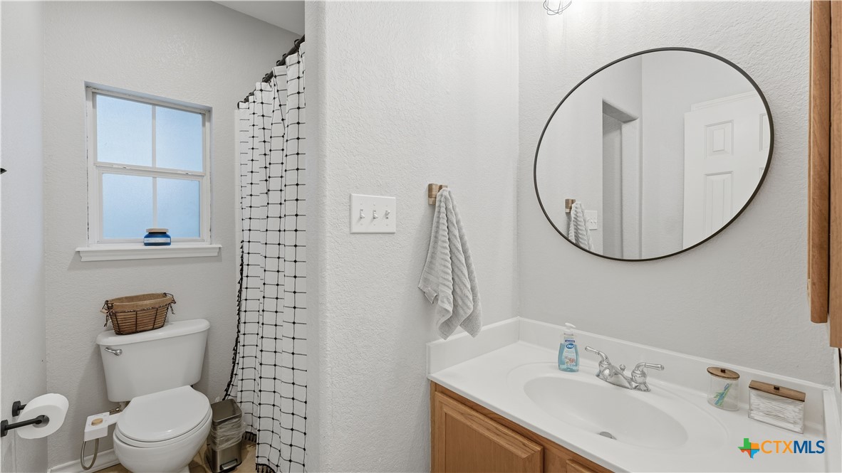 2216 Hornsby Spring Branch, TX 78070 - Photo 20 of 33 a bathroom with a sink a toilet and a mirror