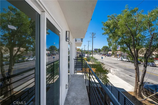 a view of a patio with chairs and potted plants