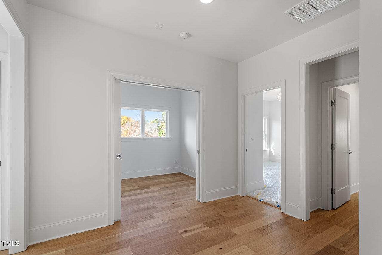 2406 Everett Avenue Raleigh, NC 27607 - Photo 11 of 40 a view of an empty room with wooden floor and a window