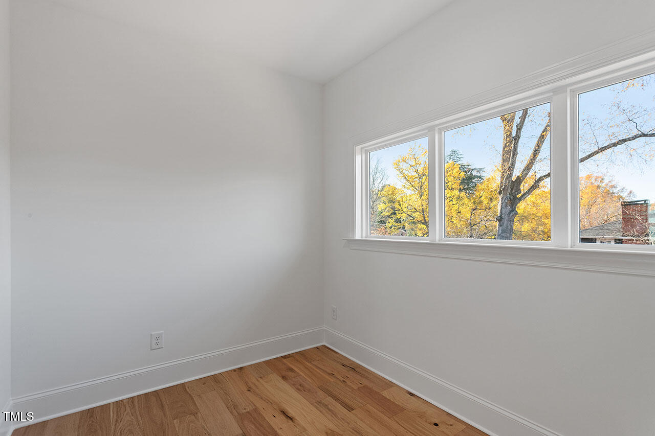 2406 Everett Avenue Raleigh, NC 27607 - Photo 12 of 40 wooden floor in an empty room with a window