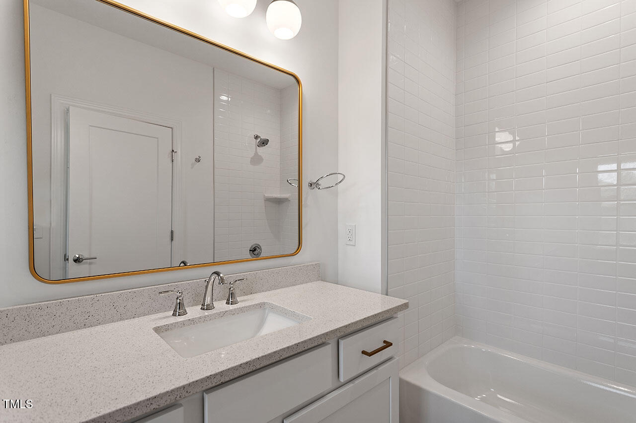 2406 Everett Avenue Raleigh, NC 27607 - Photo 15 of 40 a bathroom with a sink and a mirror