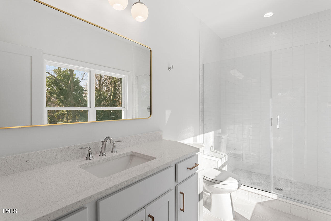 2406 Everett Avenue Raleigh, NC 27607 - Photo 18 of 40 a bathroom with a sink and a toilet