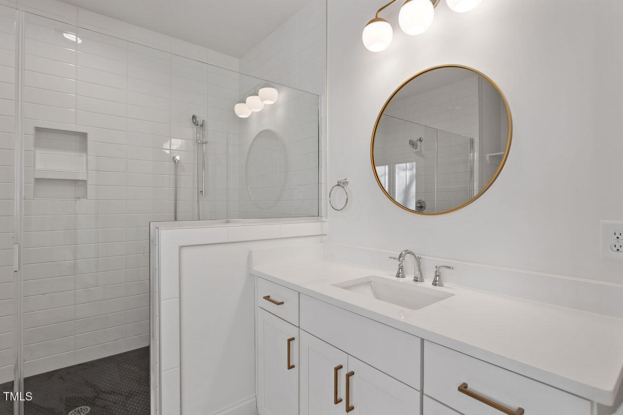 2406 Everett Avenue Raleigh, NC 27607 - Photo 23 of 40 a bathroom with a sink and a mirror
