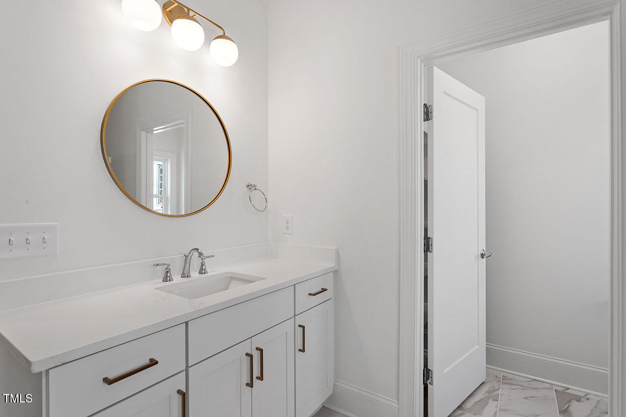 2406 Everett Avenue Raleigh, NC 27607 - Photo 24 of 40 a bathroom with a sink and a mirror