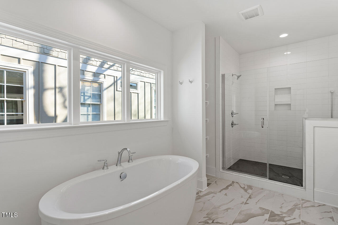 2406 Everett Avenue Raleigh, NC 27607 - Photo 25 of 40 a white bath tub sitting next to a bathroom sink