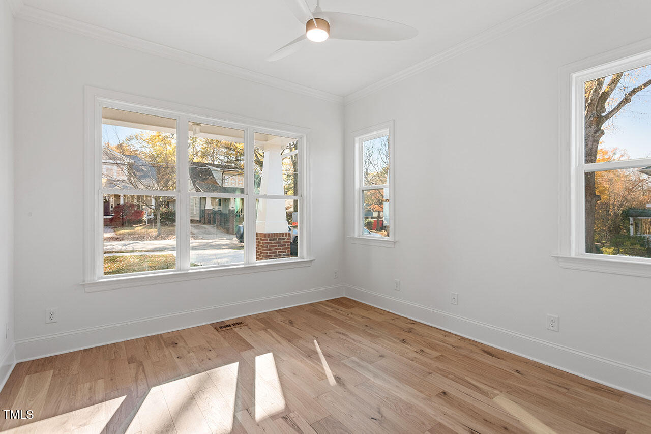 2406 Everett Avenue Raleigh, NC 27607 - Photo 28 of 40 a view of an empty room with wooden floor and a window