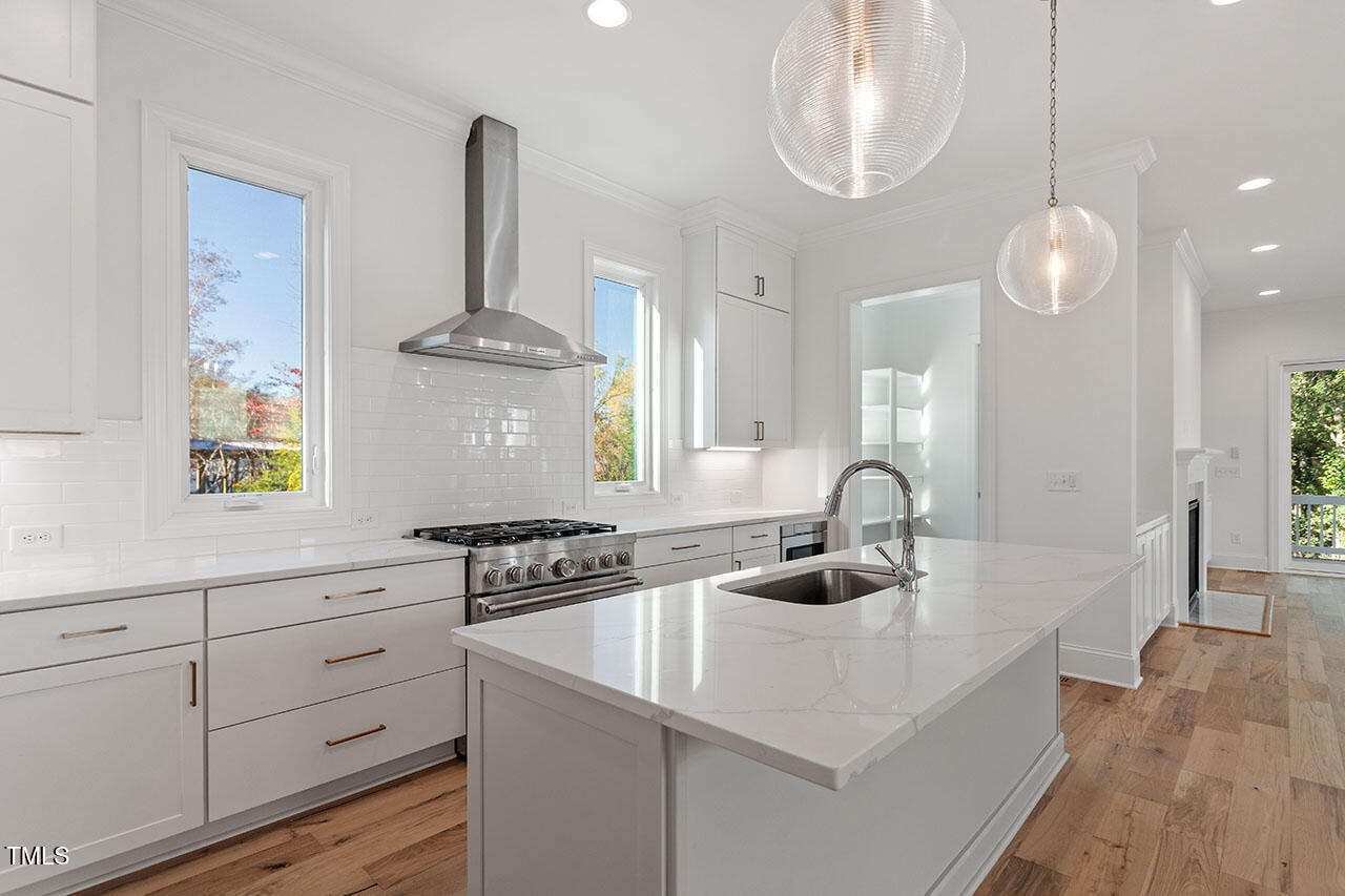 2406 Everett Avenue Raleigh, NC 27607 - Photo 31 of 40 a kitchen with a sink cabinets and window