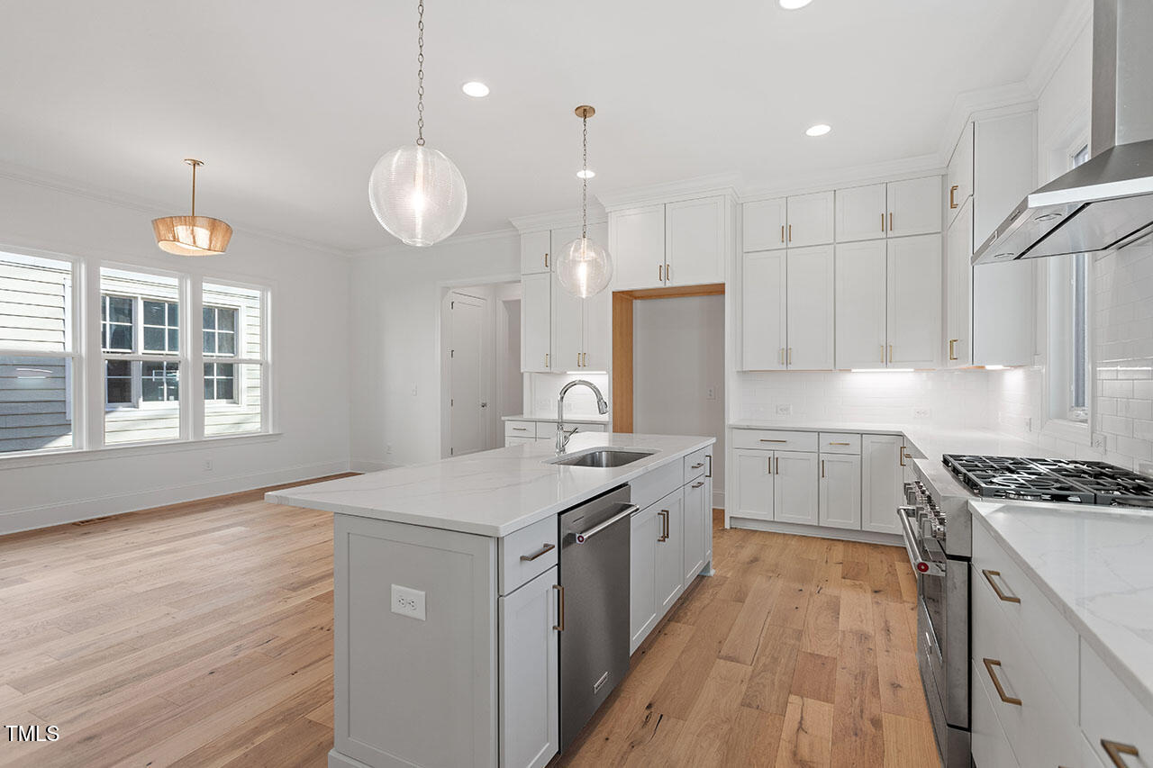 2406 Everett Avenue Raleigh, NC 27607 - Photo 34 of 40 a kitchen that has a lot of cabinets and wooden floor