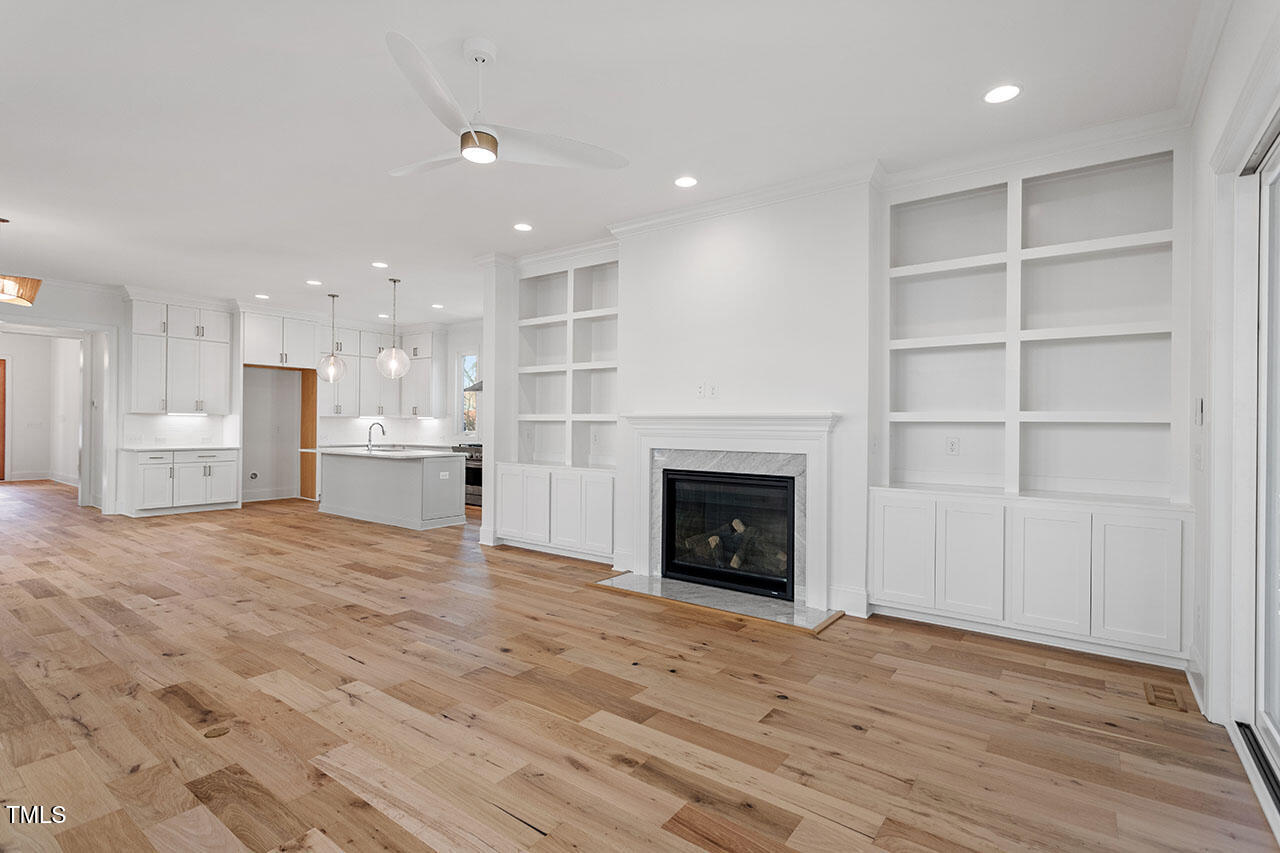 2406 Everett Avenue Raleigh, NC 27607 - Photo 37 of 40 a view of kitchen and empty room with wooden floor