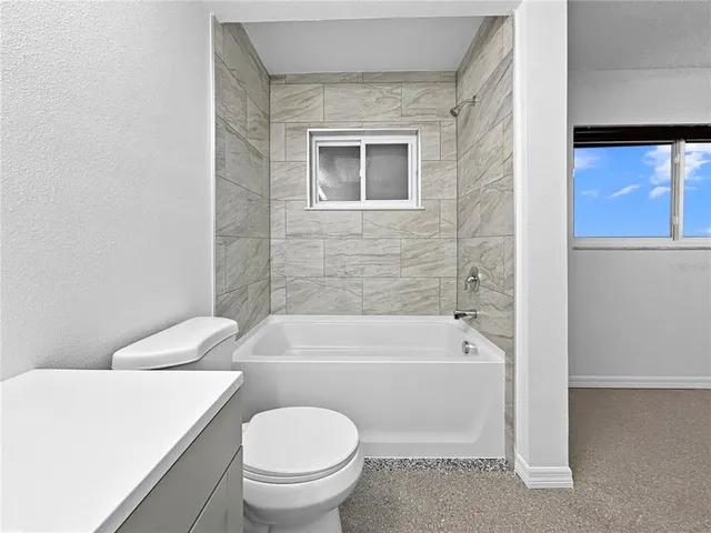 a bathroom with a sink a toilet and bathtub