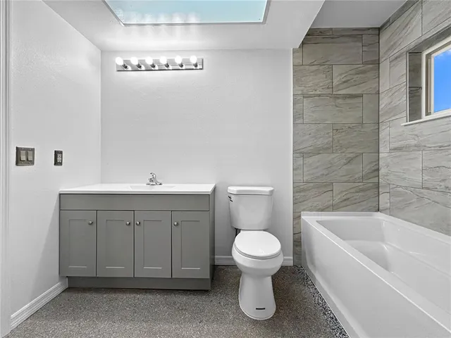 a bathroom with a sink a toilet and bathtub