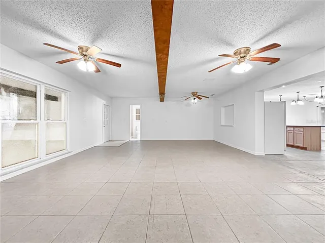 a view of empty room with ceiling fan