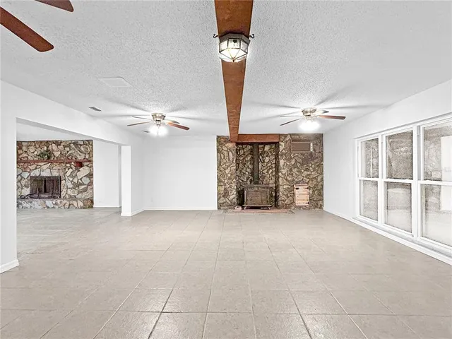 a view of a livingroom with a ceiling fan and window