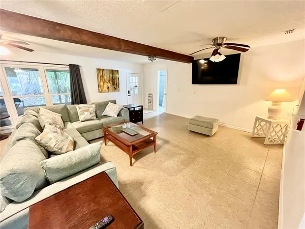 a view of a livingroom with a ceiling fan and window