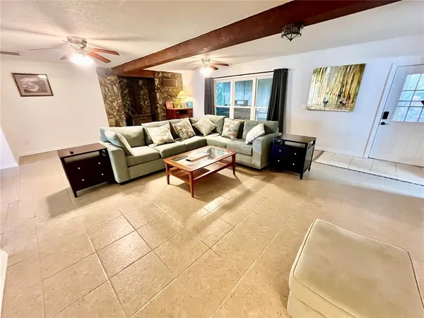 an empty room with a window and a ceiling fan