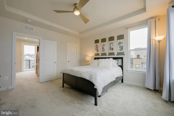 a spacious bedroom with a bed and ceiling fan