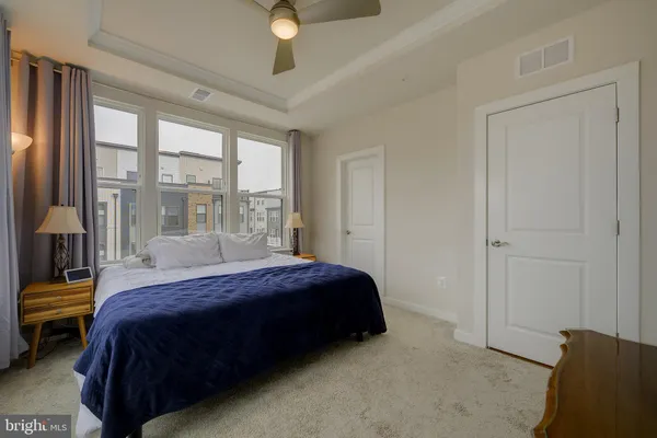 a bedroom with a bed table and window
