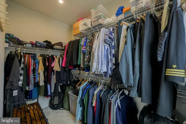 a view of walk in closet with clothes
