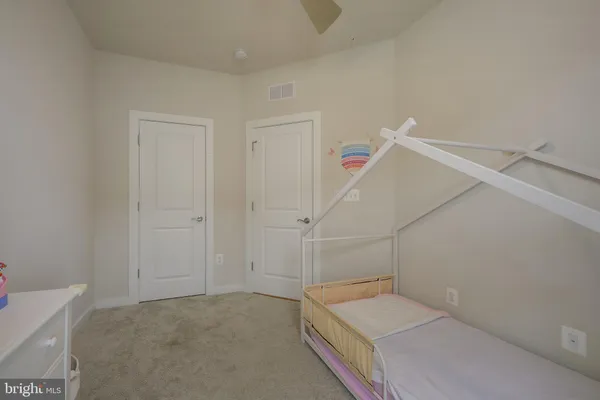 a view of a room with white walls and stairs