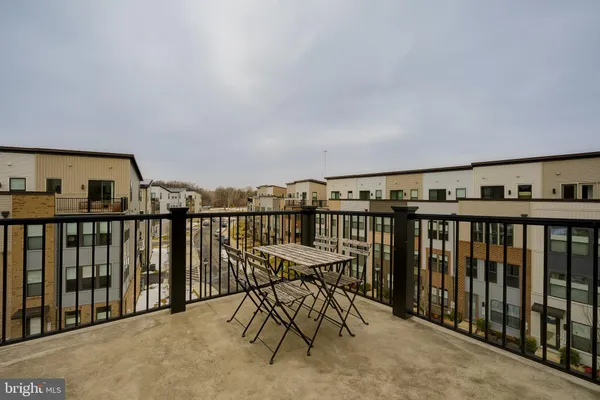 a view of a couches and dinning table in the balcony