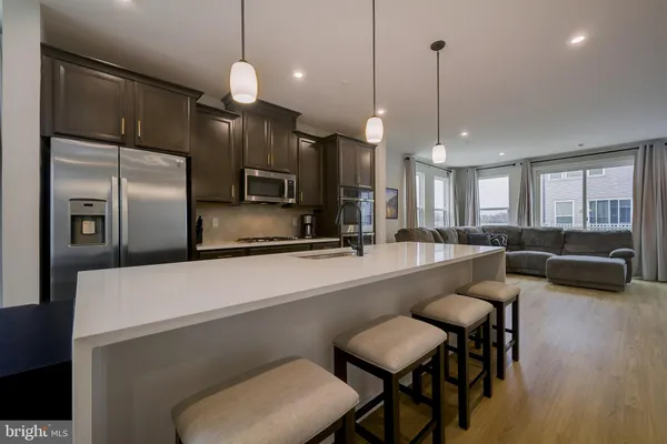 a large kitchen with a table and chairs