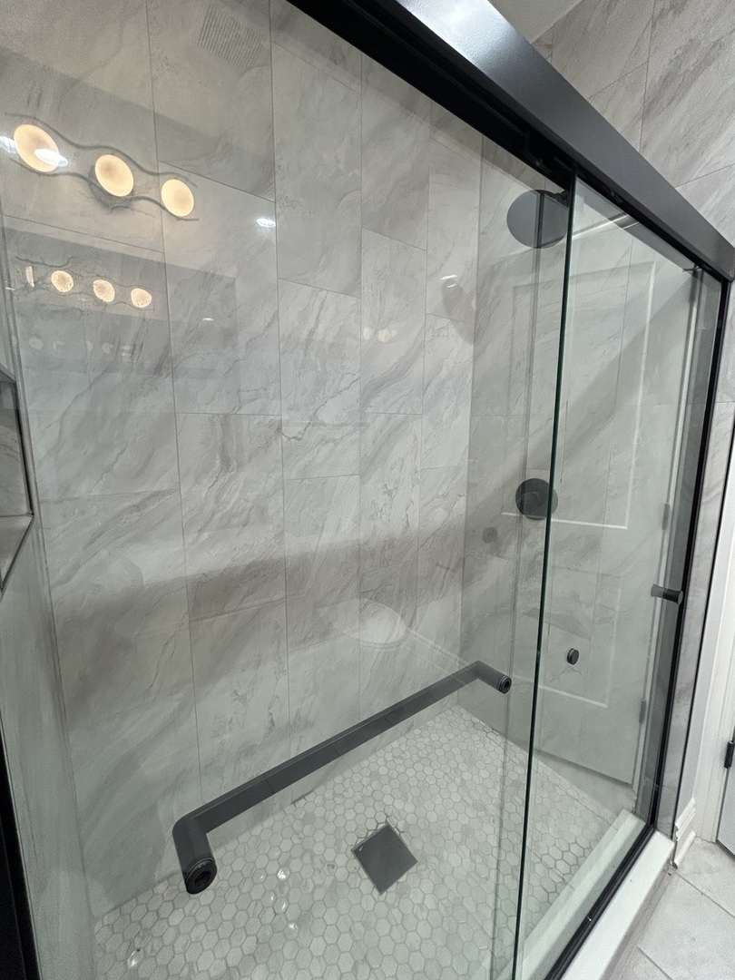 7940 South Carpenter Street, Unit 2 Chicago, IL 60620 - Photo 29 of 34 a bathroom with a glass shower door