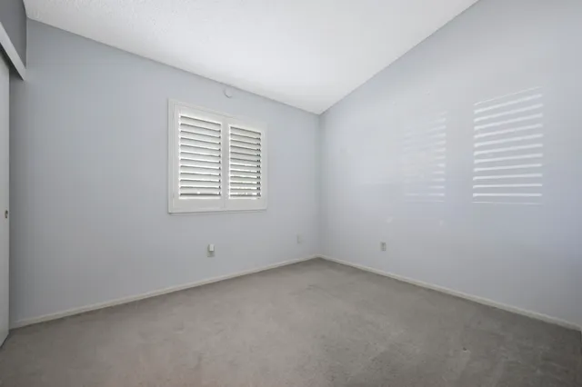 a bathroom with a sink a toilet a mirror a bathtub and shower