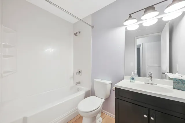 an empty room with a window and a ceiling fan