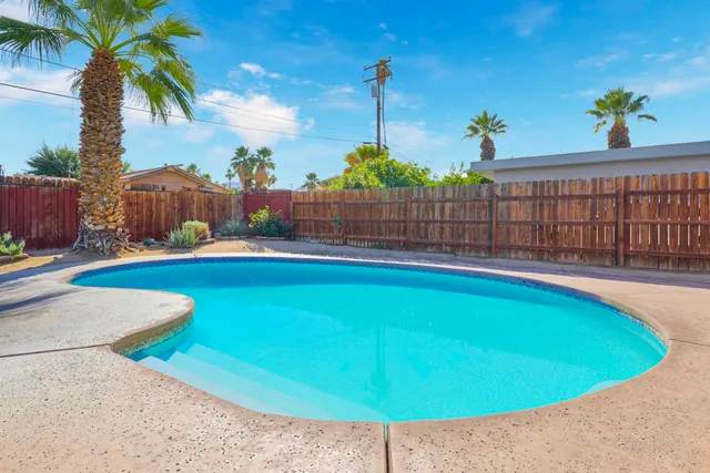 a view of swimming pool with seating area