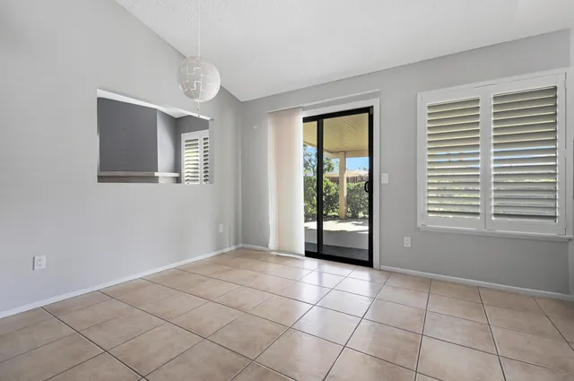 a view of a livingroom with an empty space and a window