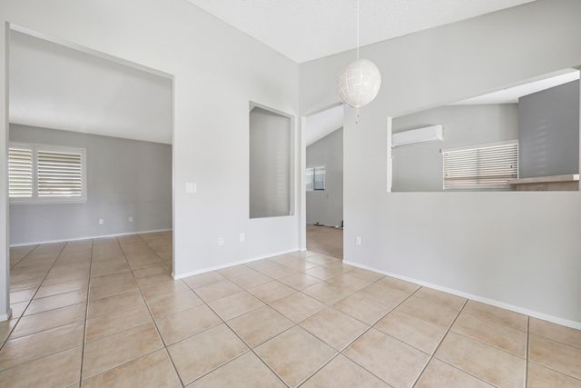 a view of an empty room with a fireplace and a window