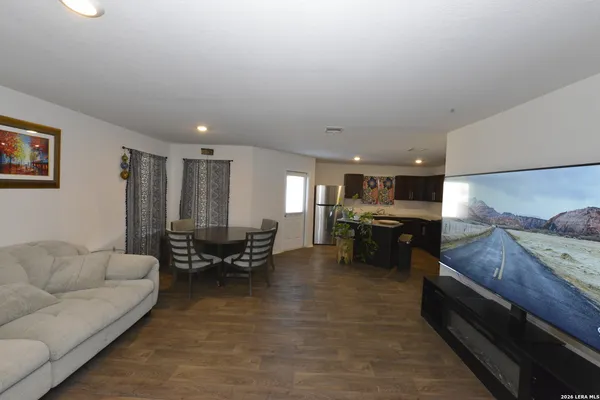 a living room with furniture and kitchen view