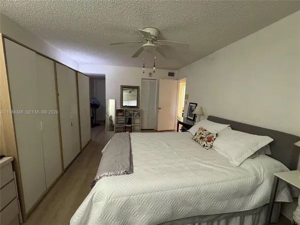 a bed room with a bed window and a mirror