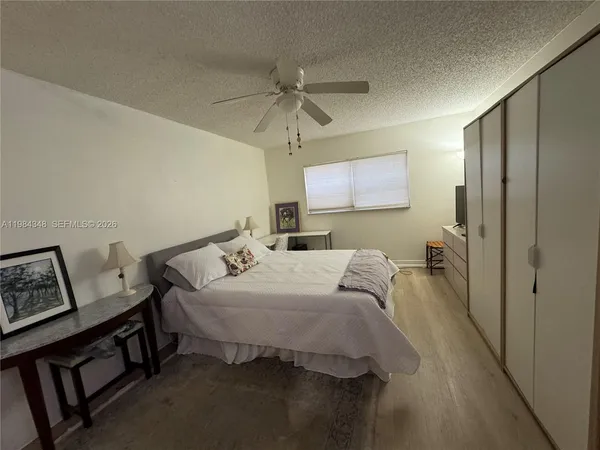 a spacious bathroom with a toilet sink and a mirror