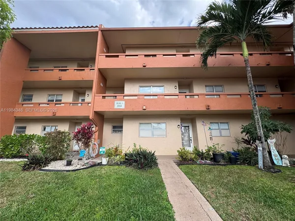 a view of a house with a yard and plants