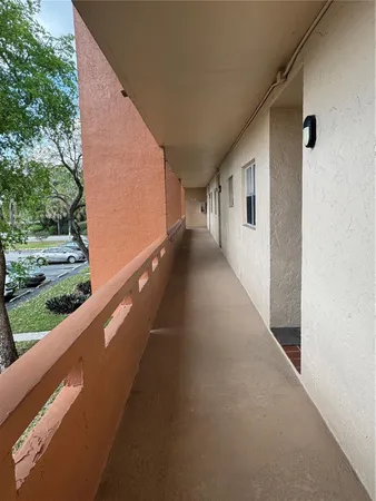 a view of entryway with a floor to ceiling window and potted plants