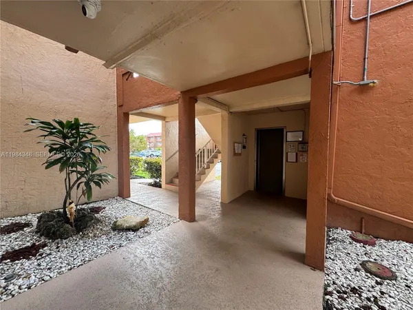 a kitchen with a refrigerator and a sink