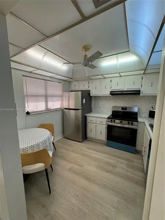 a kitchen with a refrigerator and a stove