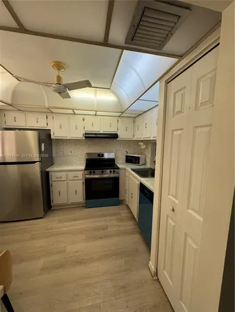 a kitchen with a stove a sink and a refrigerator
