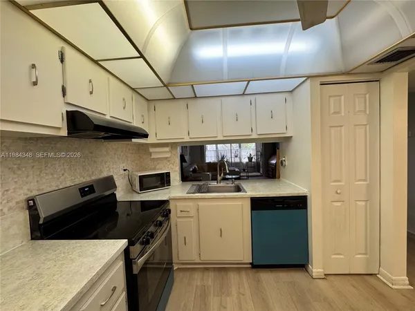 a living room with furniture a flat screen tv and a window