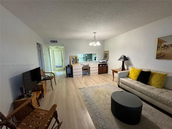 a view of a livingroom with furniture and a potted plant