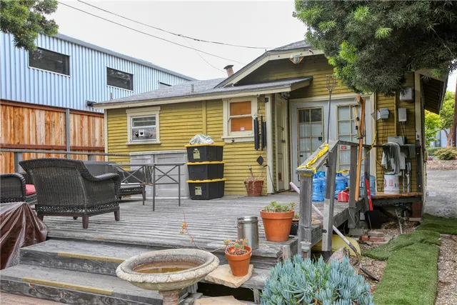 a view of a patio with table and chairs potted plants and large tree