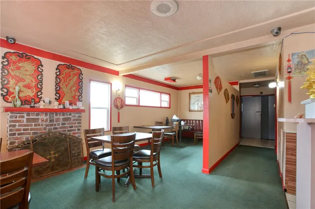 a dining room with furniture and a floor to ceiling window
