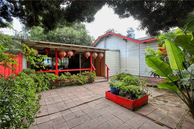 a front view of a house with garden