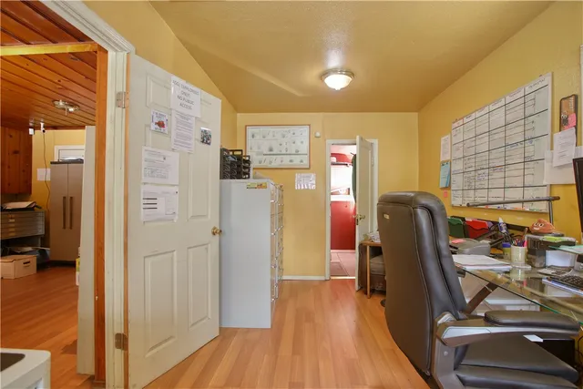 a view of a workspace with furniture and wooden floor