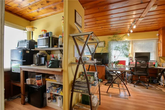 a living room with lots of furniture and a wooden floor