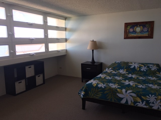 84 Pukihae Street, Unit 804 Hilo, HI 96720 - Photo 6 of 16 a bed sitting in a bedroom next to a window